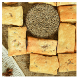 Khari , the Square crackers with cumin seeds on a textured surface - indiansupermarkt